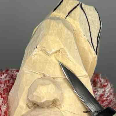 Carving back eye sockets on wood carved pear