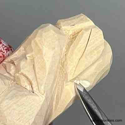 Shaping the leaf on wood carved pear caricature