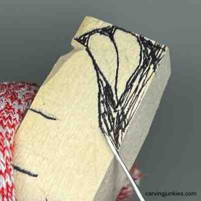 Staring to remove wood on pear caricature