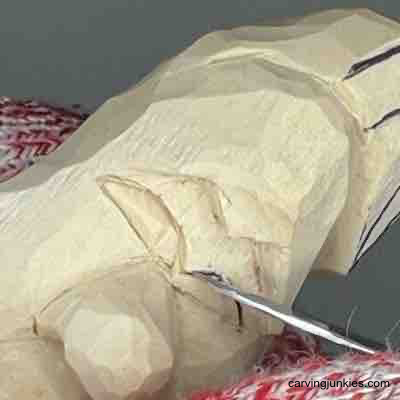 Carving eyes on wood carved pear