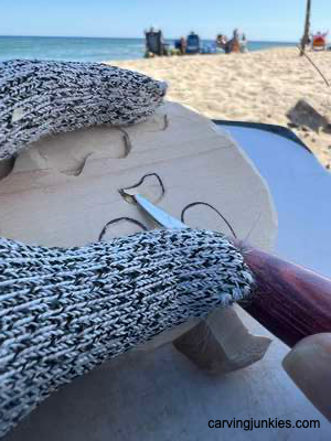 Removing wood to carve nose on ghost pumpkin