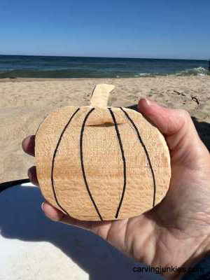 Back ridge lines sketched on wooden pumpkin