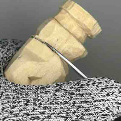 Shaping side of wood carved scarecrow