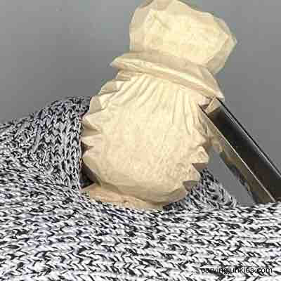 Carving hair on wooden scarecrow