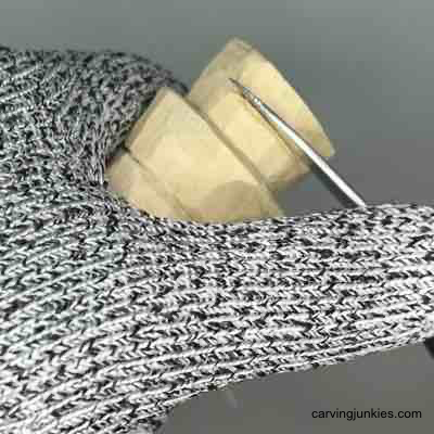 Starting to carve feet on wood carved scarecrow