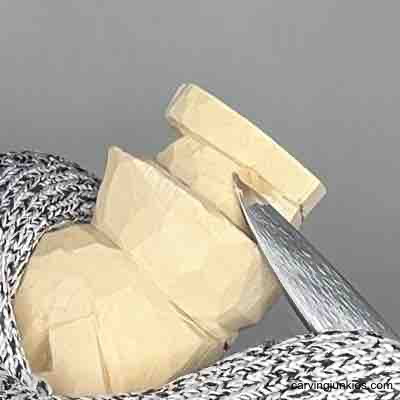 Carving the foot line on wood carved scarecrow