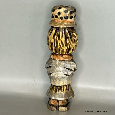 Back view of painted wood carved scarecrow