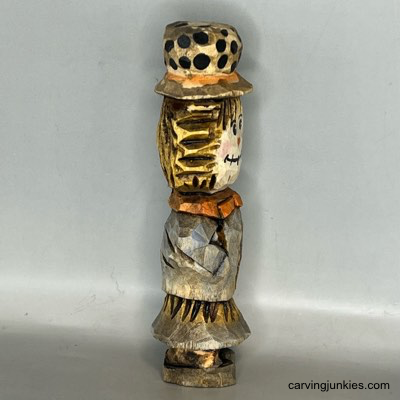 Right view of painted wood carved scarecrow