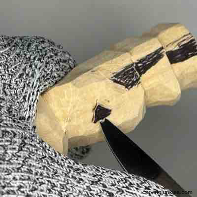 Making a pyramid cut on wood carved scarecrow