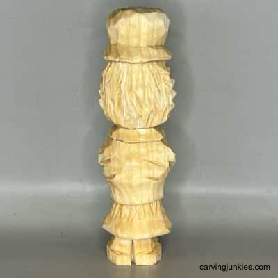 Back view of unpainted wooden scarecrow carving