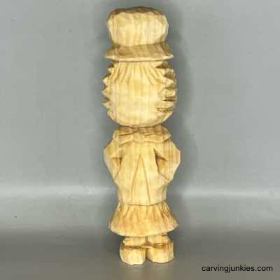 Front of unpainted wooden scarecrow carving