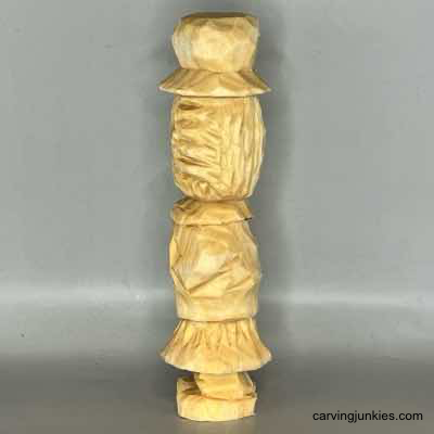 eft view of unpainted wooden scarecrow carving