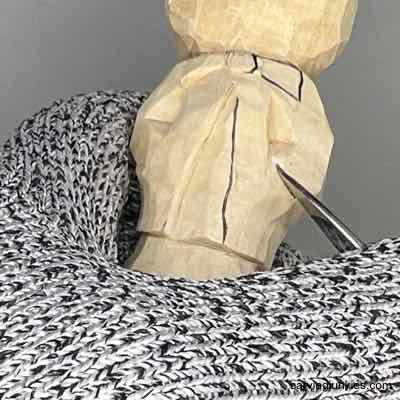 Separating details on wood carved scarecrow