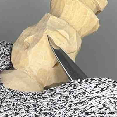 Narrowing front of wood carved scarecrow