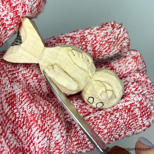 Shaping the flippers on wood carved seal