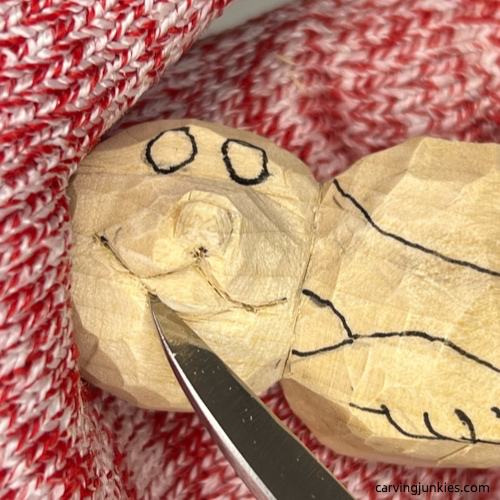 Separating the facial details on wood carved seal