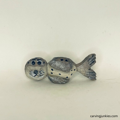 Front view of painted wood carved seal