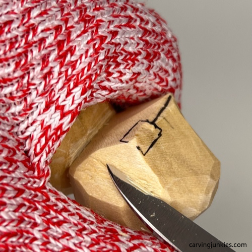 Carving back the snout on the wood carved seal