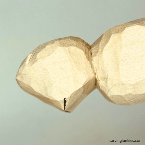 Shaping snout of wood carved seal