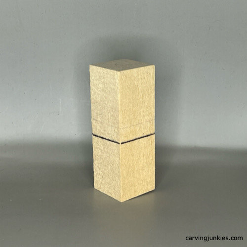 Guidelines on front of wood block for carving a four-leaf clover