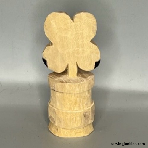 Wood is marked for removal to carve a wooden four-leaf clover