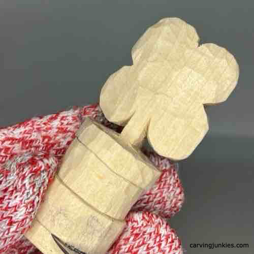 Carving sections of wood to make a four-leaf clover