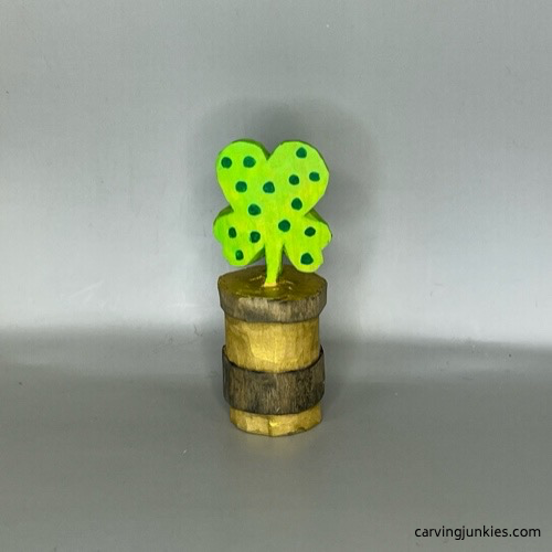 Back view of completed wood carved four-leaf clover after painting