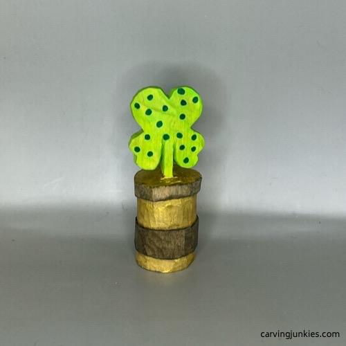 Front view of wooden four-leaf clover carving after painting