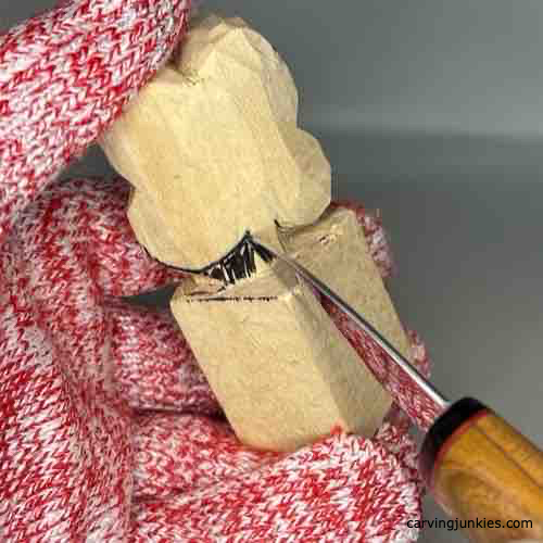 Making a pyramid cut on wood for carving a four-leaf clover