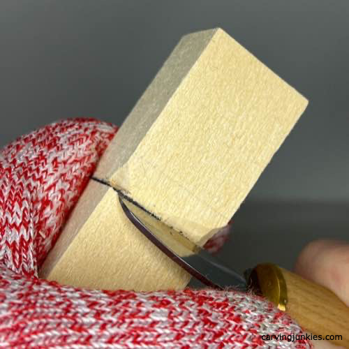 Separating wood with a stop cut to carve a four-leaf clover