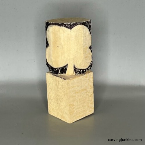 Sketched design on wood to carve a four-leaf clover