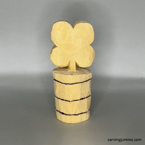 Sketched lines to guide carving a wooden four-leaf clover