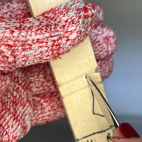 Separating the scarf on wood carved snowman