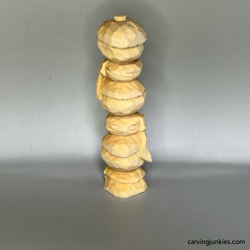 Back view of unpainted wood carved snowman