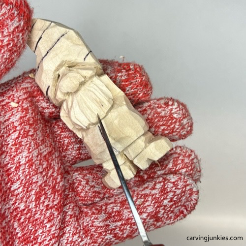 Carving details on beard of wood carved Valentine gnome