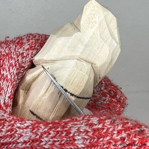 Separating bottom of nose on wood carved valentine gnome