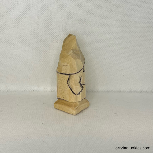 Right arm is drawn on wood carved valentine gnome