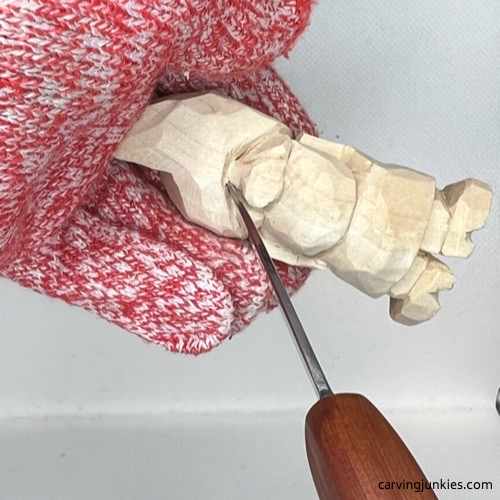 Making stab cut for eye on wood carved Valentine gnome
