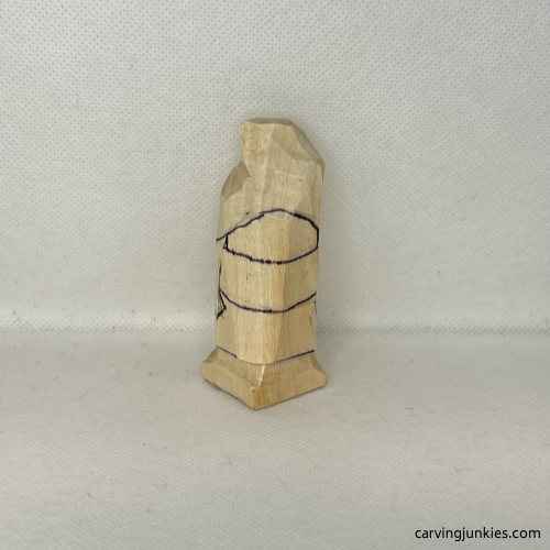 Front guidelines are drawn on wood carved valentine gnome