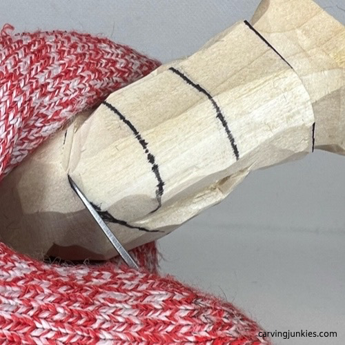 Separating the head on wood carved valentine gnome