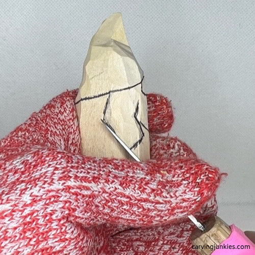 Stop cut on arm of wood carved Valentine gnome
