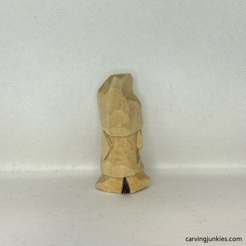 Wood is marked for removal on back of wood carved valentine gnome