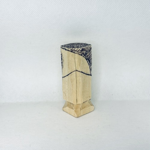 Hat is sketched on wood carved valentine gnome