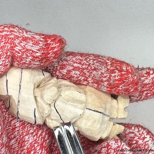 Using soft V tool on beard of wood carved Valentine gnome