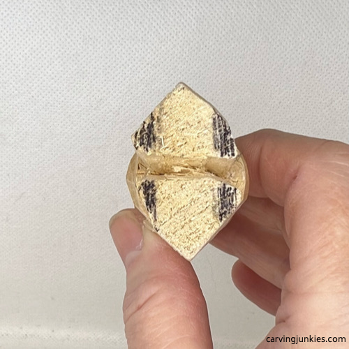 Shaping shoes on wood carved valentine gnome