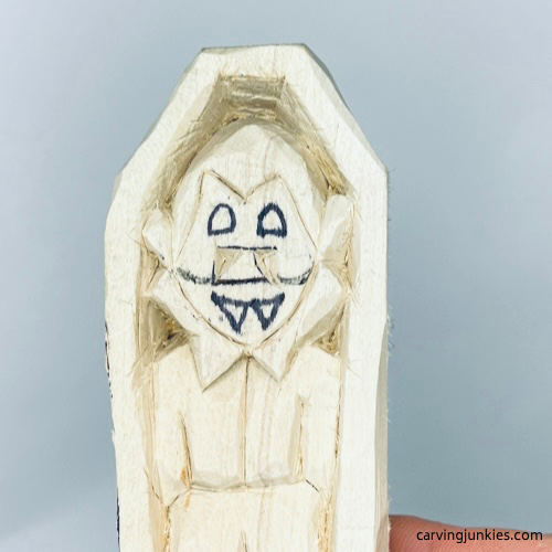 Cheeks drawn on wood carved vampire