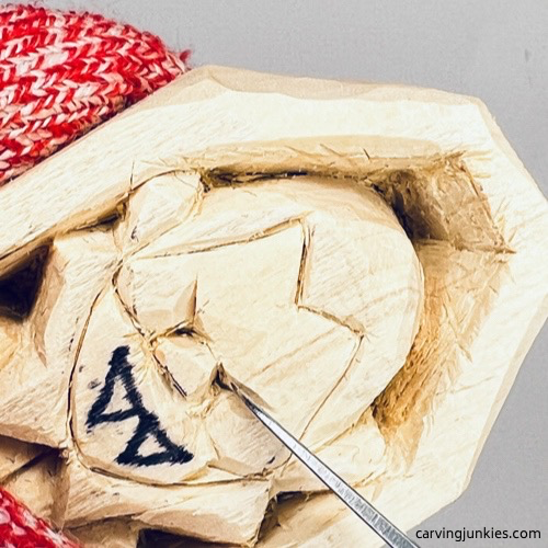 Carving eyes on wood carved vampire