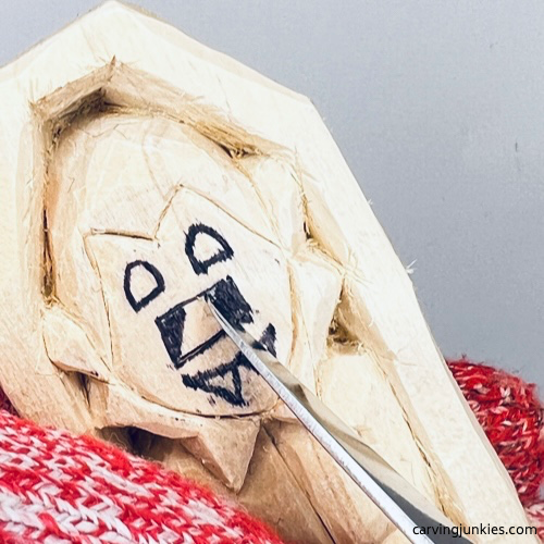 Starting pyramid cut on wood carved vampire