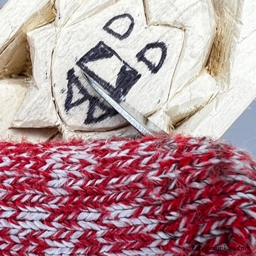 Making a stop cut under the nose of wood carved vampire