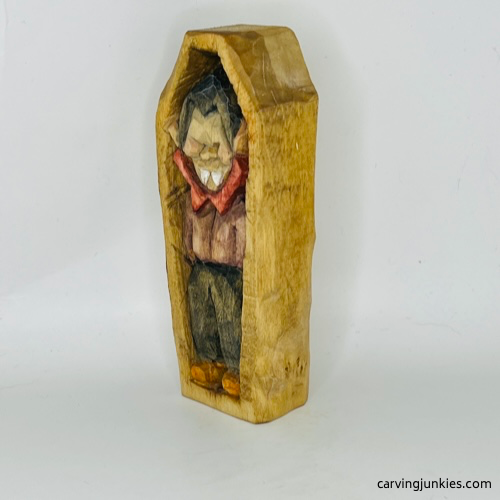 Left view of painted wooden vampire carving